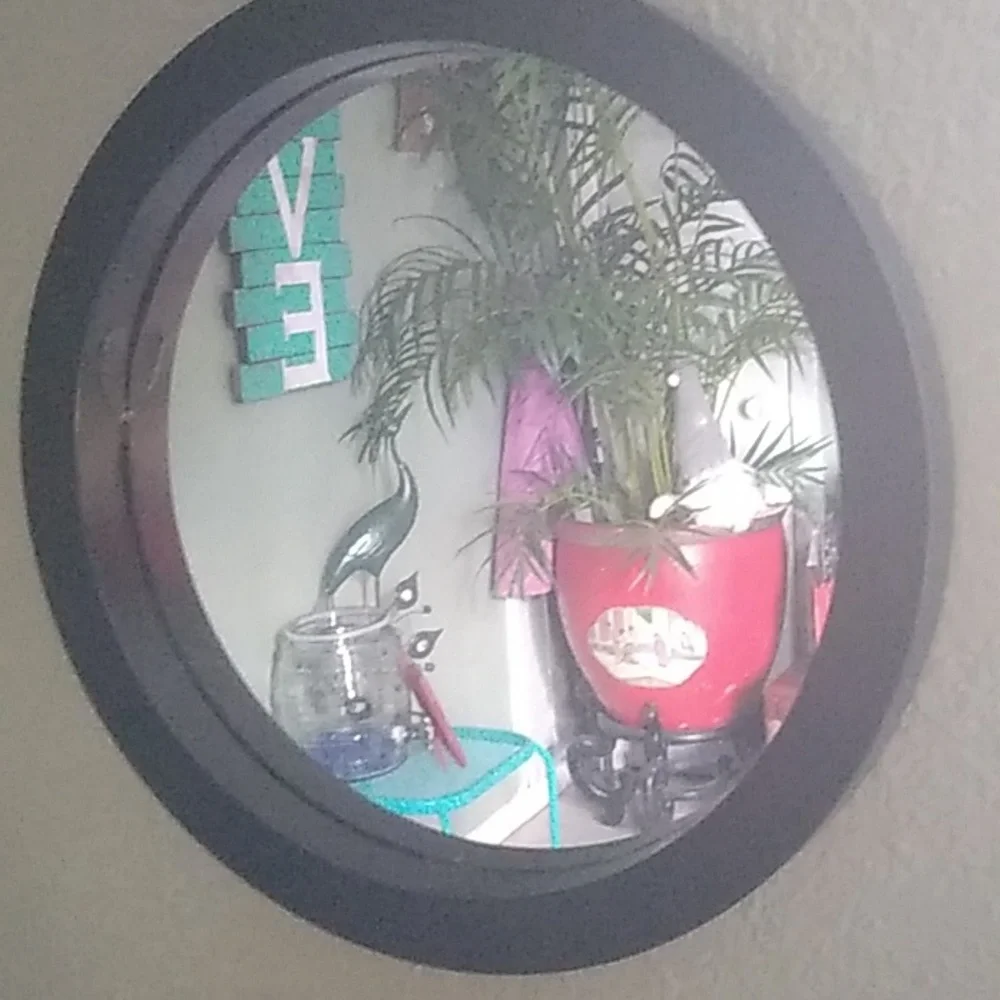 Four black round wall mirrors